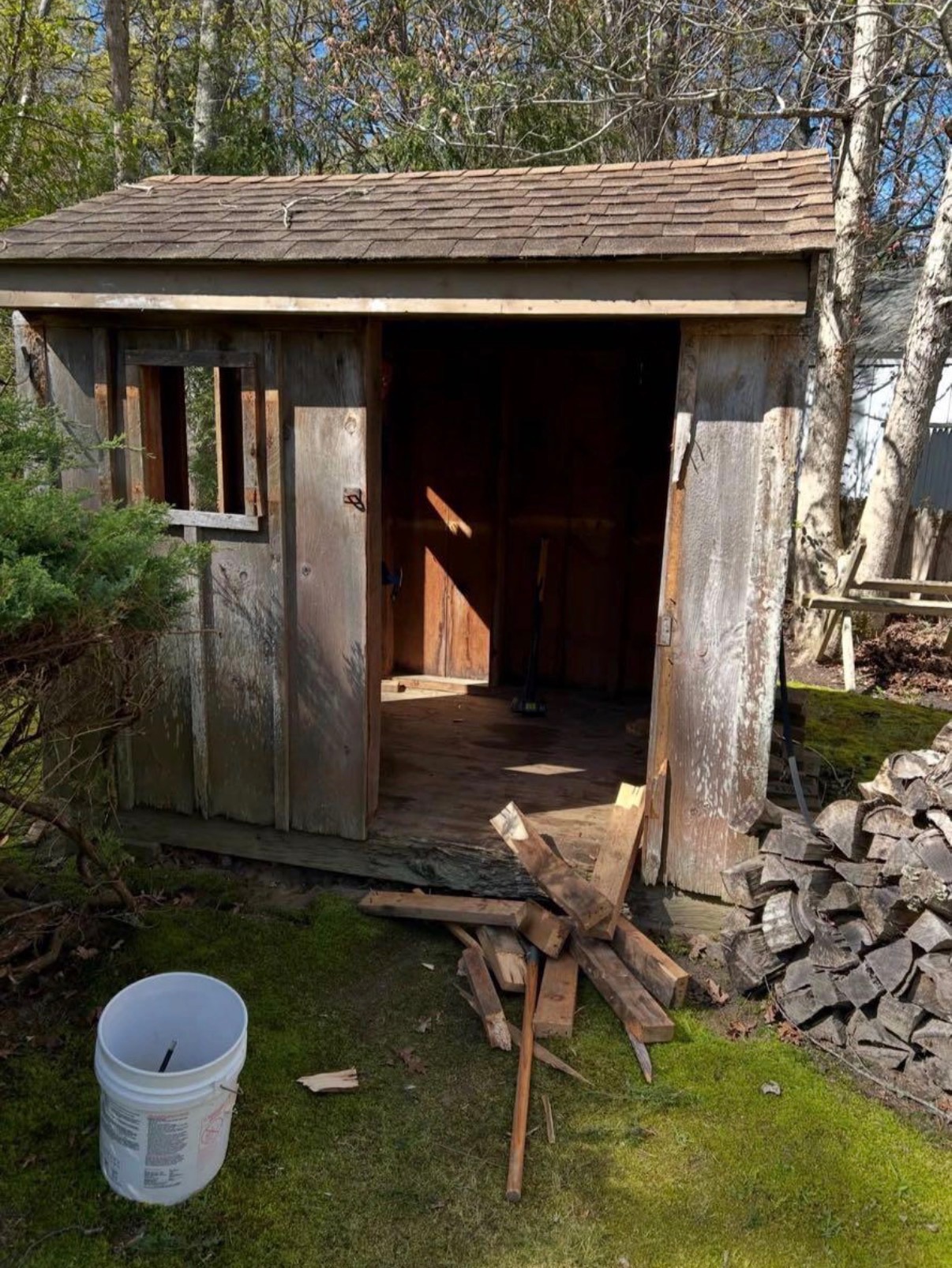 Amaru Bros mid-demolition of an old wooden shed in a Cape Cod backyard