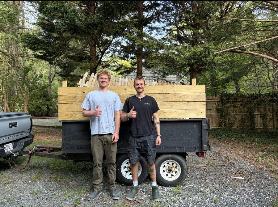 Brothers Kevin and Brian Amaru standing in front of their Amaru Bros Removal work trailer on Cape Cod